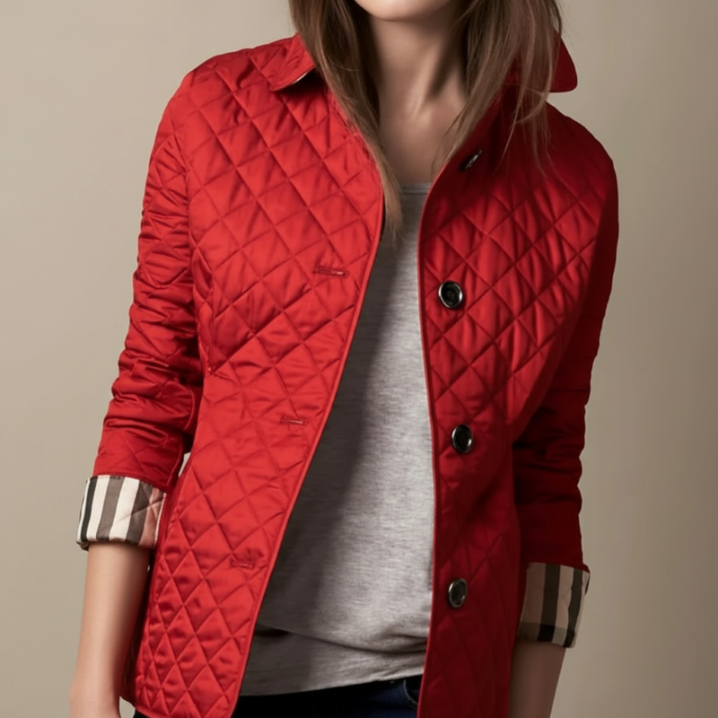 Red quilted jacket worn by a person on a beige background