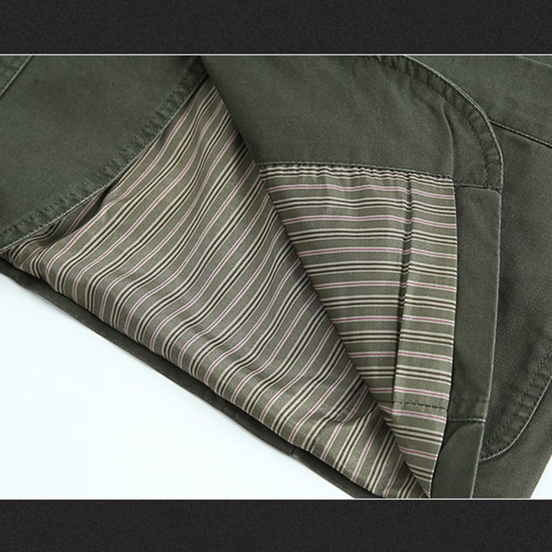 Close-up of green fabric with striped lining on a white background