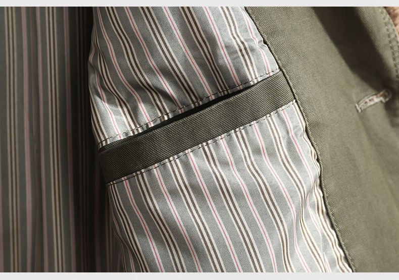 Close-up of a striped fabric with a black strap and green fabric background