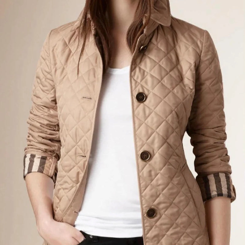 Beige quilted jacket worn by a person on a beige background