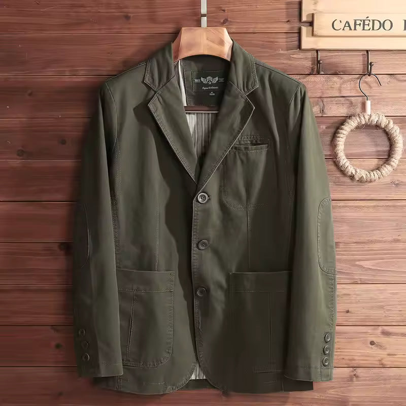 Green jacket on a hanger against a wooden wall with 'CAFéDO' branding.