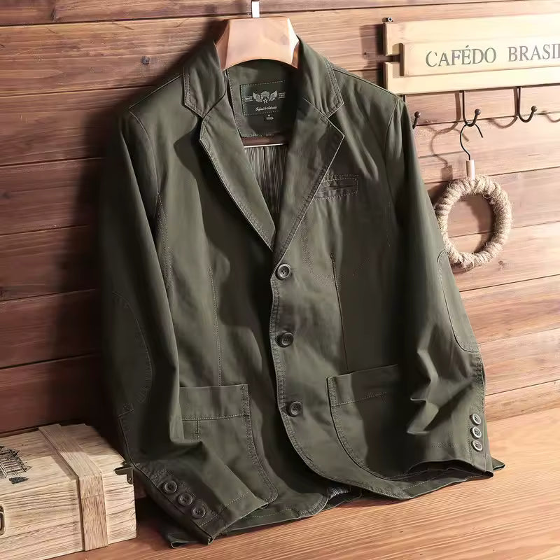 Green jacket on a wooden hanger against a wooden wall with 'Cafédo Brasíl' sign.
