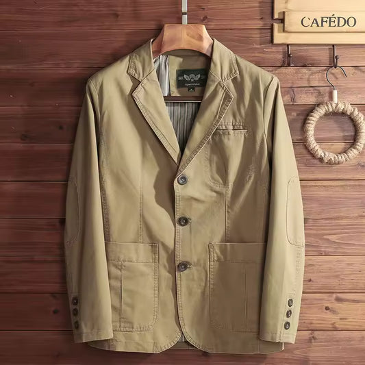 Khaki jacket on a hanger against a wooden wall with 'CAFEÓ' branding.
