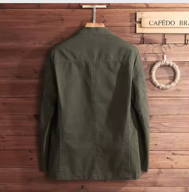 Green jacket on a hanger against a wooden wall with 'CAFEÓ' branding.