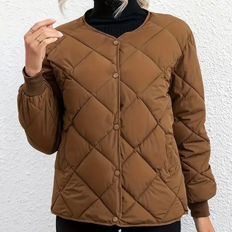Brown quilted jacket worn by a person against a white background