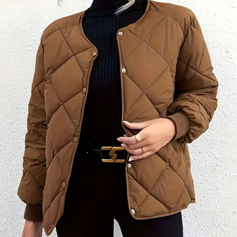 Brown quilted jacket worn by a person against a white background