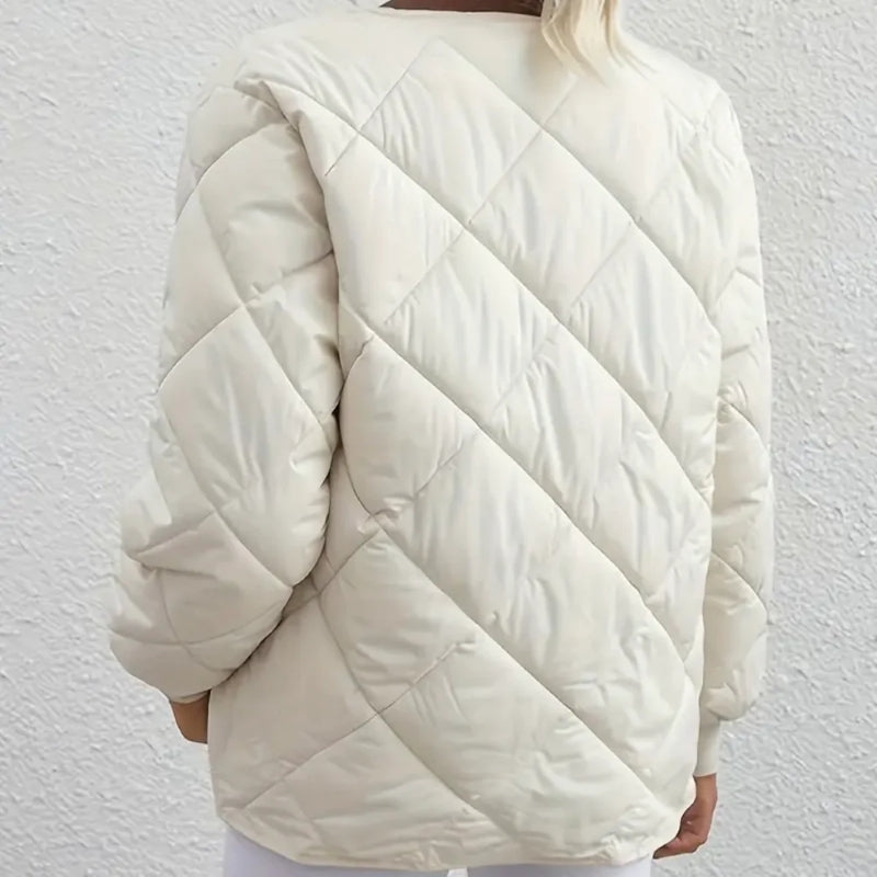 White quilted jacket worn by a person against a white background