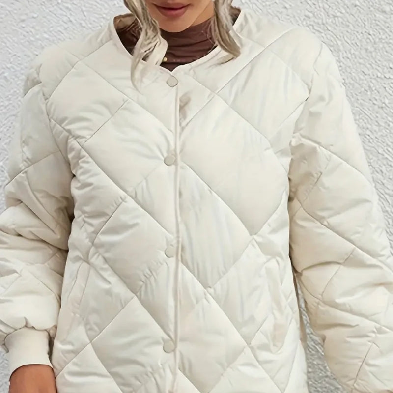 White quilted jacket worn by a person against a white background
