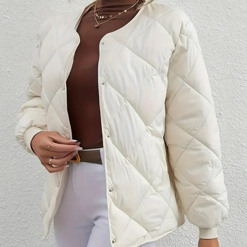 White puffer jacket worn by a person on a light gray background
