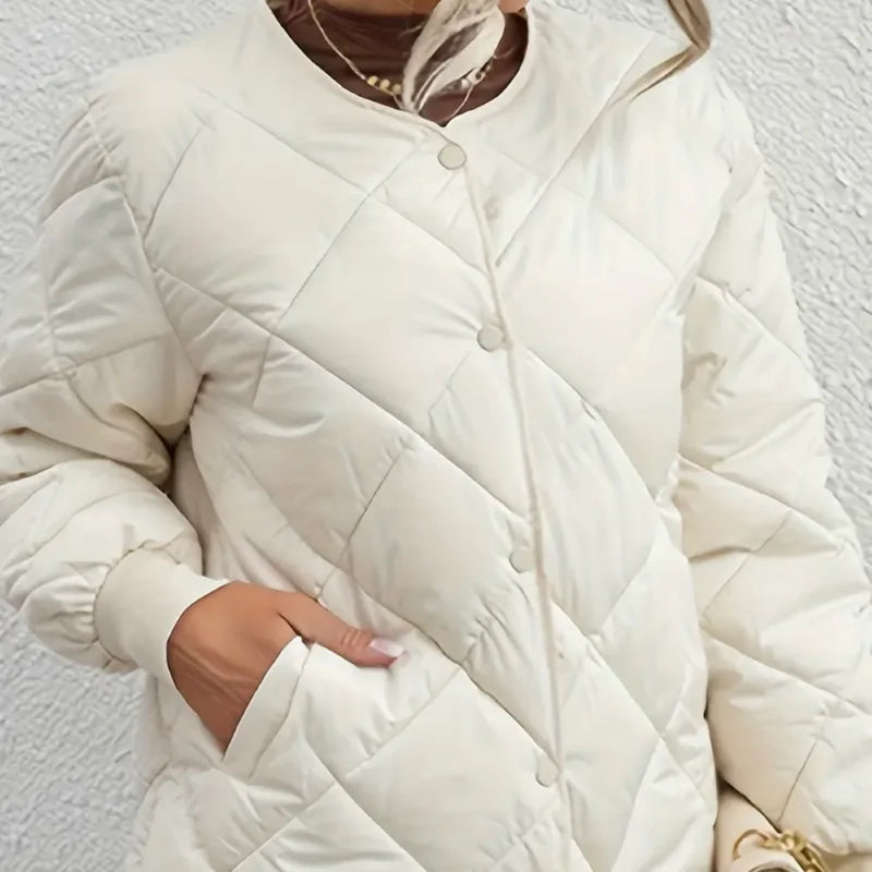 White quilted jacket worn by a person against a light background
