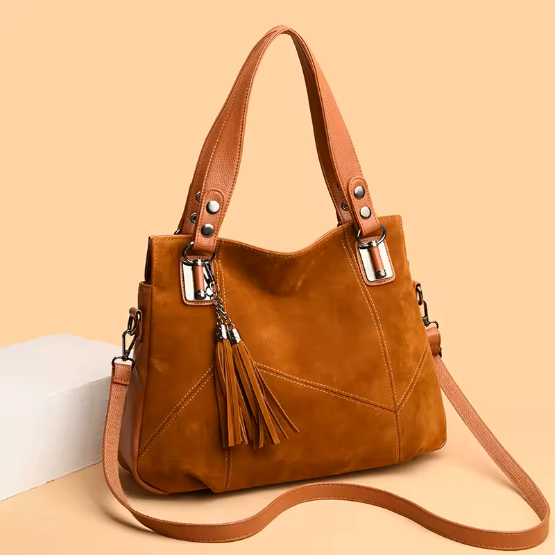 Brown handbag with tassels on a beige background