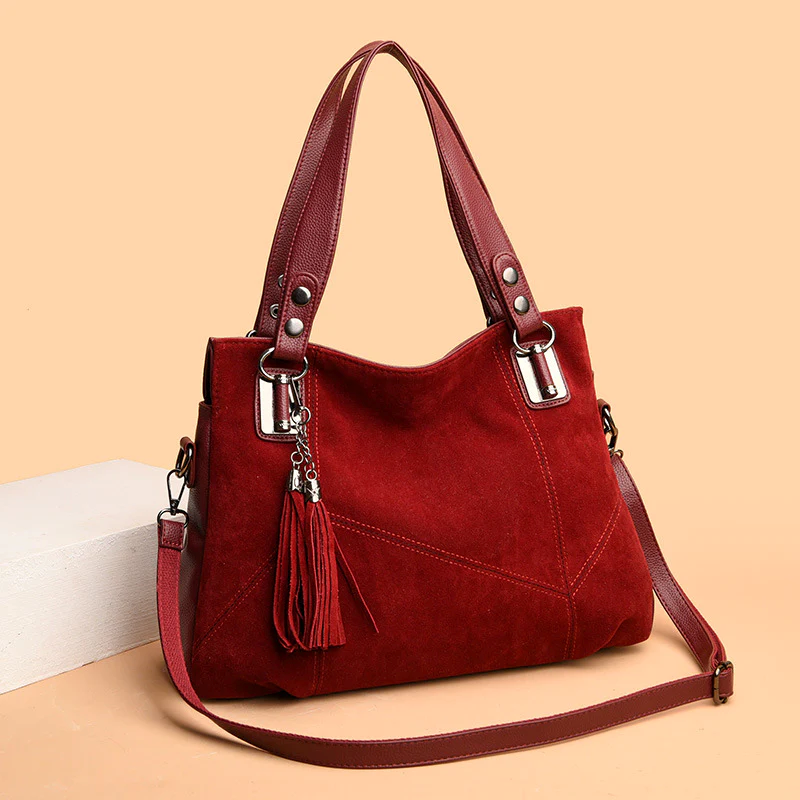 Red handbag with a strap on a beige background