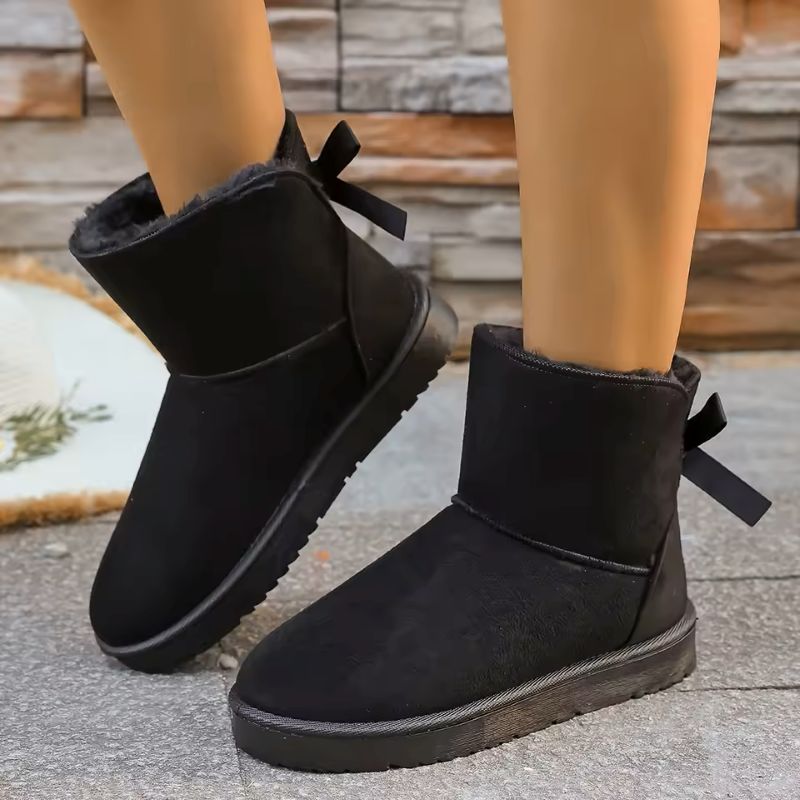 Elara fur-lined winter boots in black with bow detail