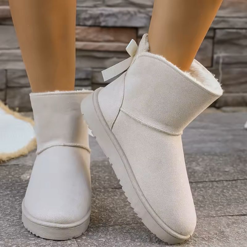 Elara fur-lined winter boots in white with bow detail