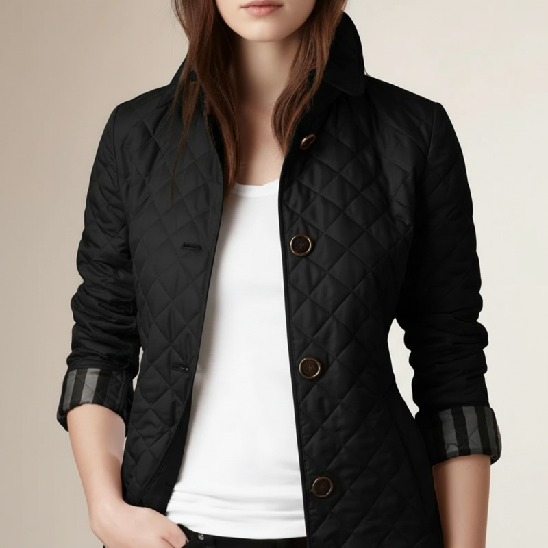 Black quilted jacket worn by a person on a beige background